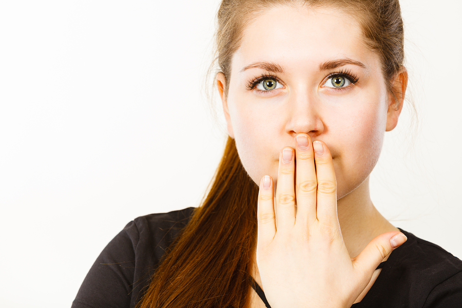 Woman covering her mouth with her hand